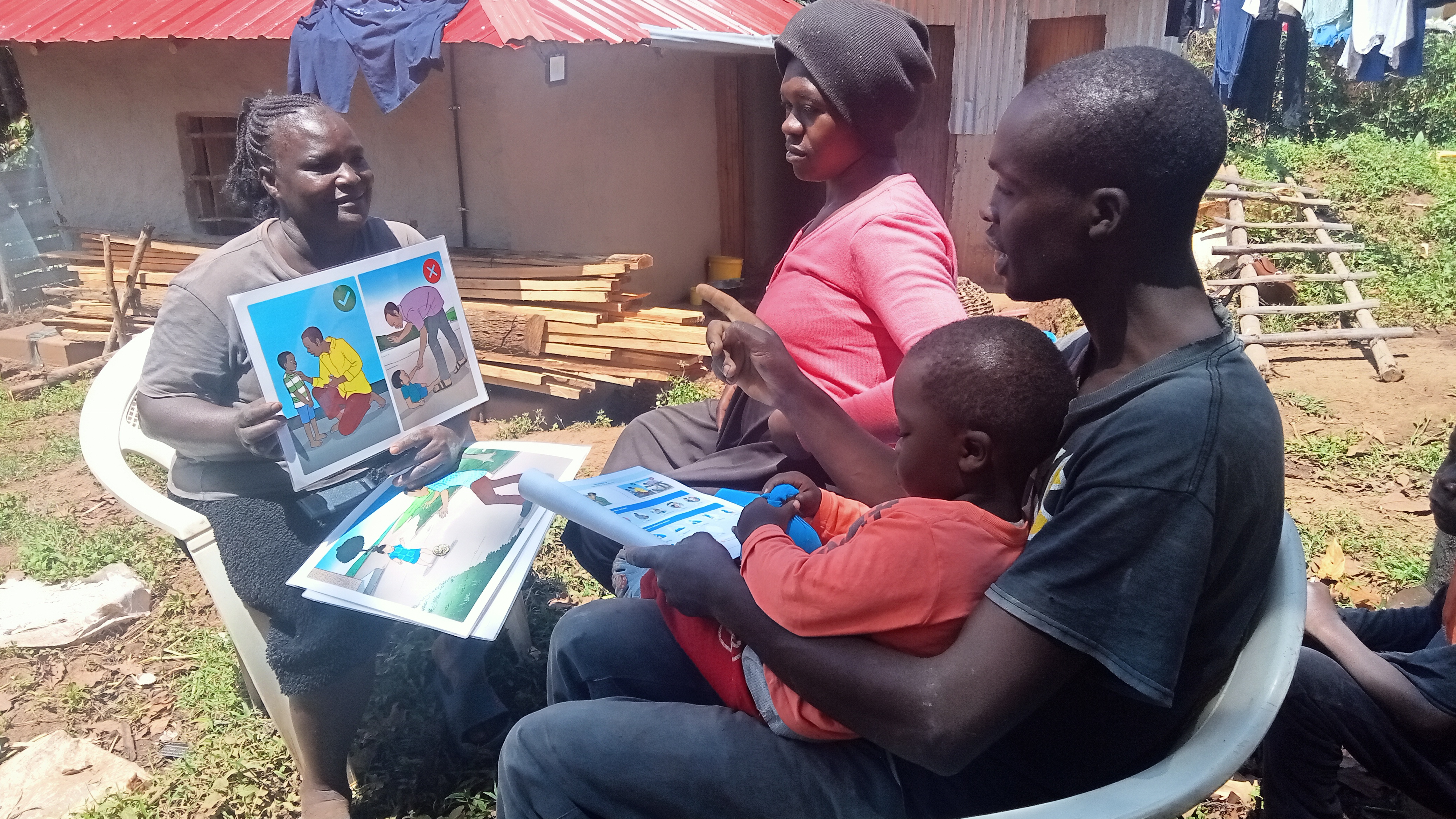 A father, Joshua, playing with his son or holding his pregnant wife's hand in Nyamira.